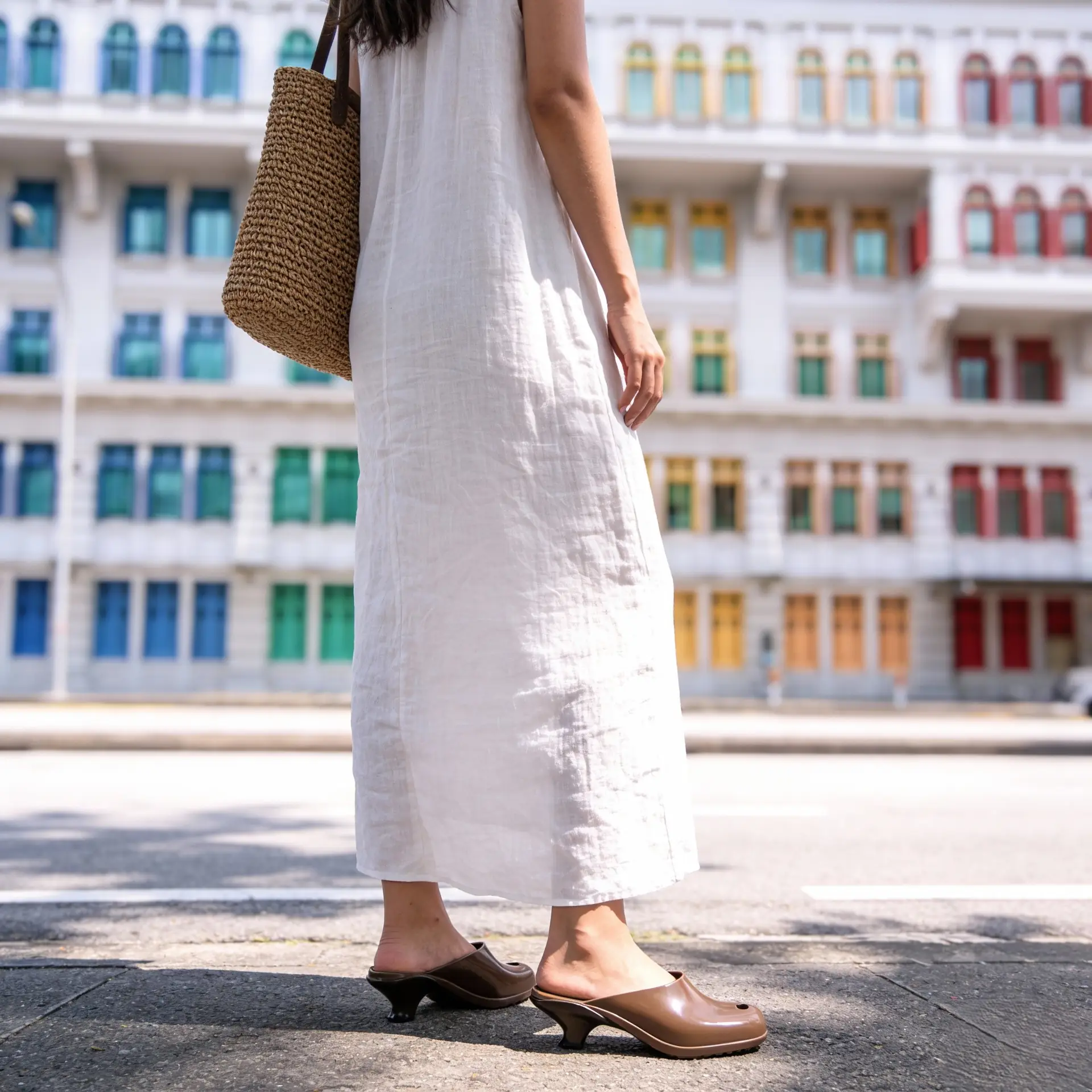 Melissa Carousel fashion ad: Lifestyle ad for everyday comfort in leather mules on a city street, frame 1 of 2