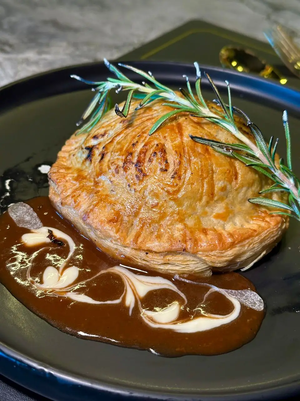 The Ocean Peak Carousel food and beverage ad: Showcase ad for a golden beef Wellington in glossy sauce, frame 1 of 6