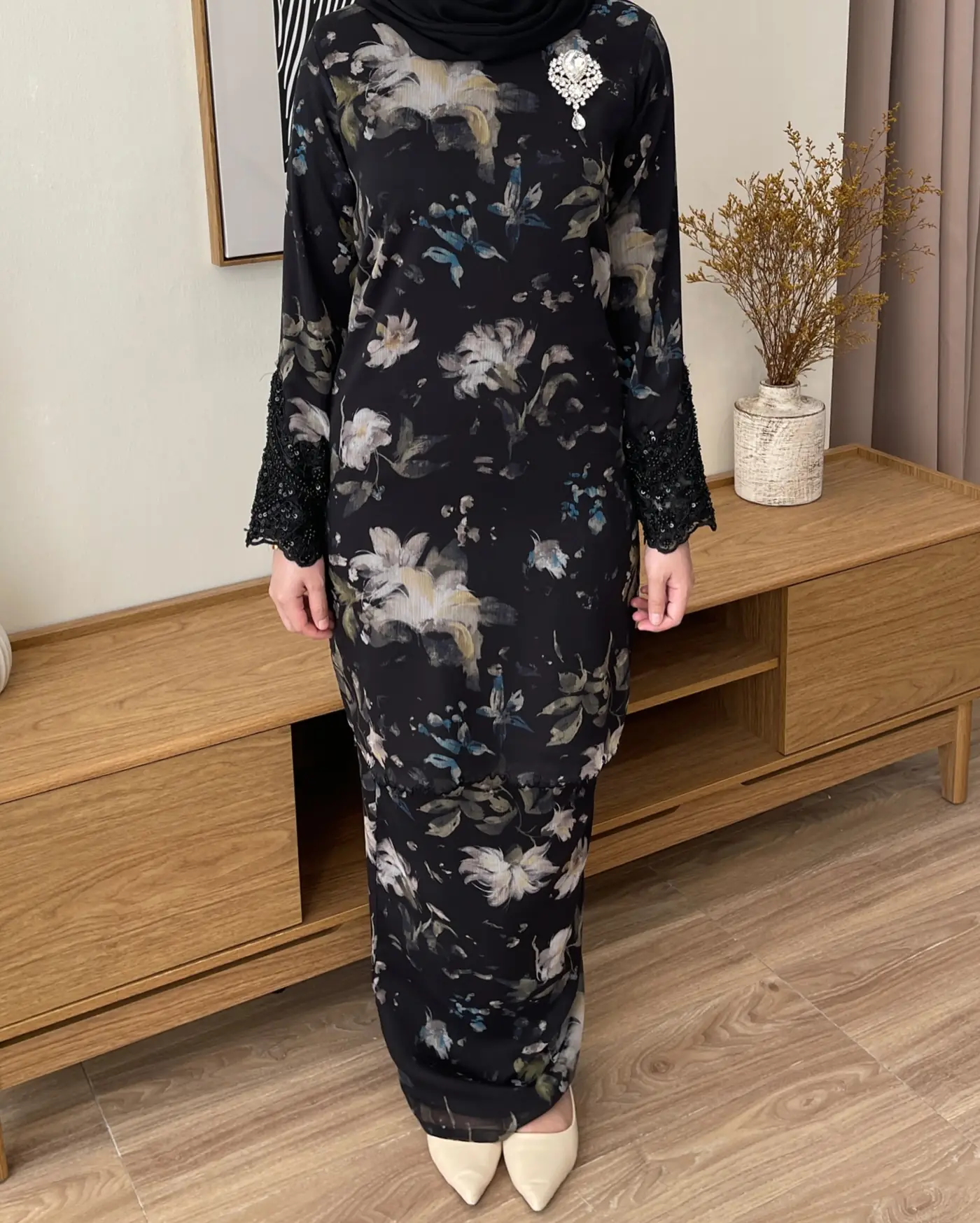 Nadine Couture Carousel fashion ad: Showcase ad for a black floral festive modest dress with beaded lace cuffs, frame 1 of 4